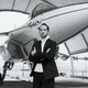 A black and white photo of Patrice Meignan stood in front of a plane.